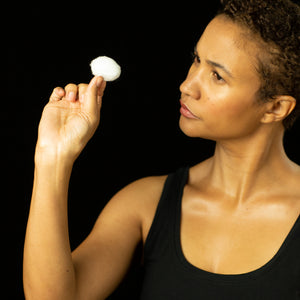 Woman looking at cotton ball